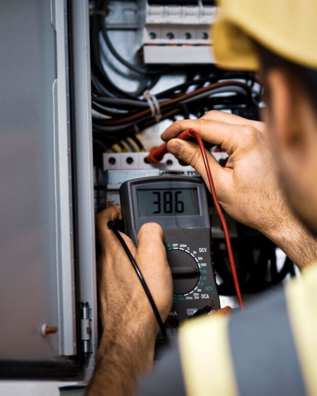 An electrician fixing an electrical panel